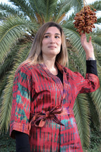 Load image into Gallery viewer, Girl wearing a green and red tie dye kimono, touching a grape of dates