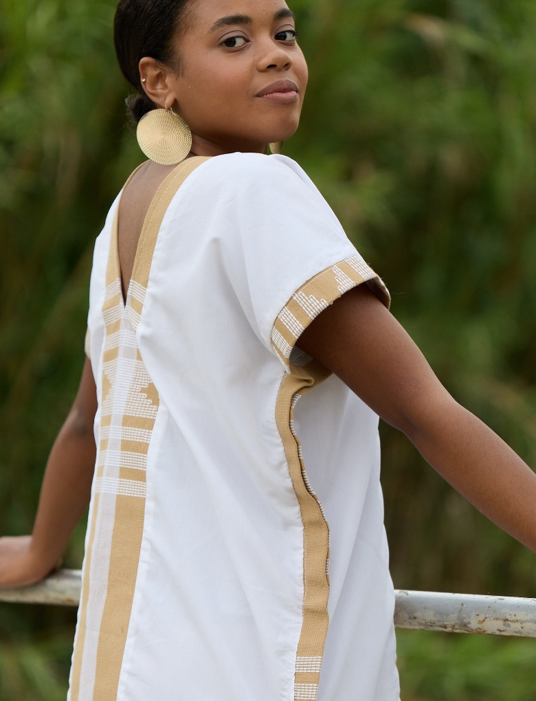 Close-up of the Savannah Kaftan's beige and white handwoven Asooke trim on cotton