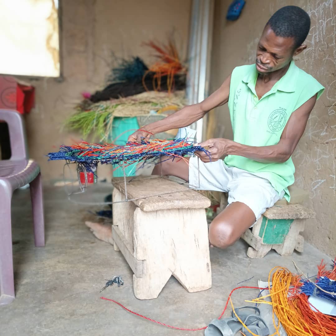 Artisan hands weaving a natural fiber basket