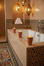 Carregar imagem no visualizador da galeria, Bathroom with bathtub, candles in terracotta pots, and decorative tiles.
