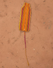 Carregar imagem no visualizador da galeria, Orange pink woven banana leaf laying on an earthen ground
