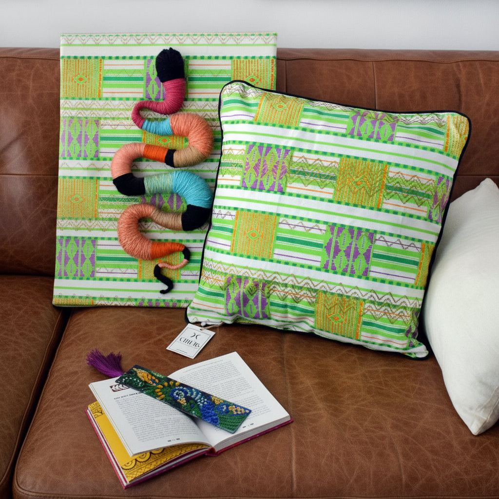 Wax Print Cushion cover with green geometric patterns, displayed on a sofa with a snake artwork.