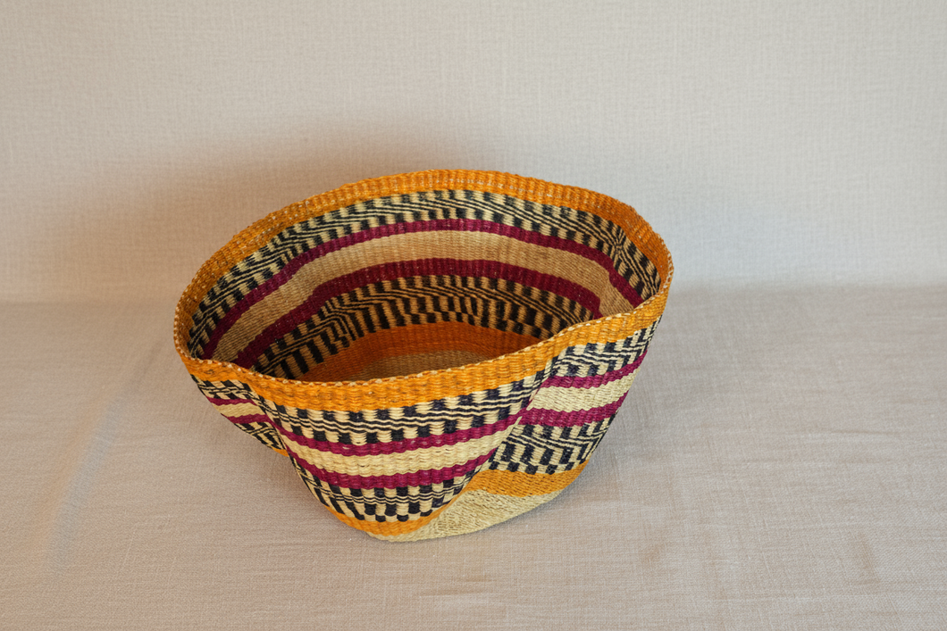 Woven basket with multicolored pattern on a beige background