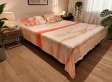 Load image into Gallery viewer, A reversible duvet cover with one side featuring a tie-dye pattern in shades of pink and orange and the other side a plain salmon pink cotton cloth.
